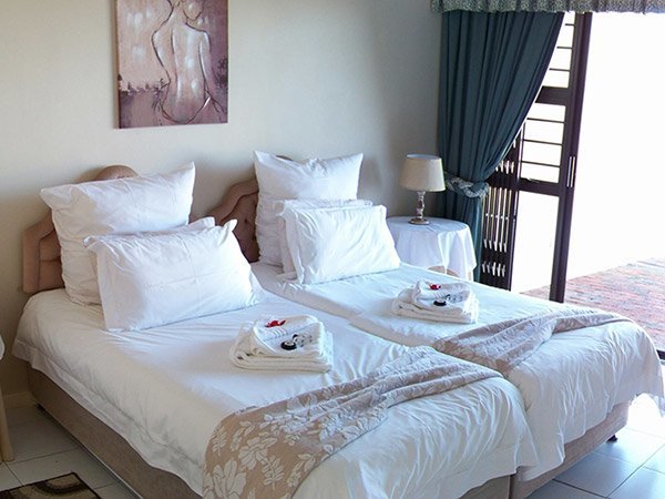 Two single beds in a bright two bedroom room