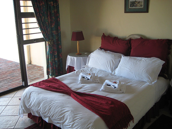 Large bed in a three bedroom apartment with outside terrace